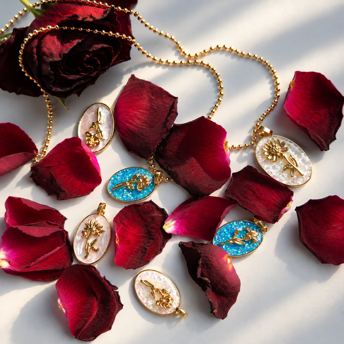 Selection of gold birth flower oval pendants with shell and opal-look inlays