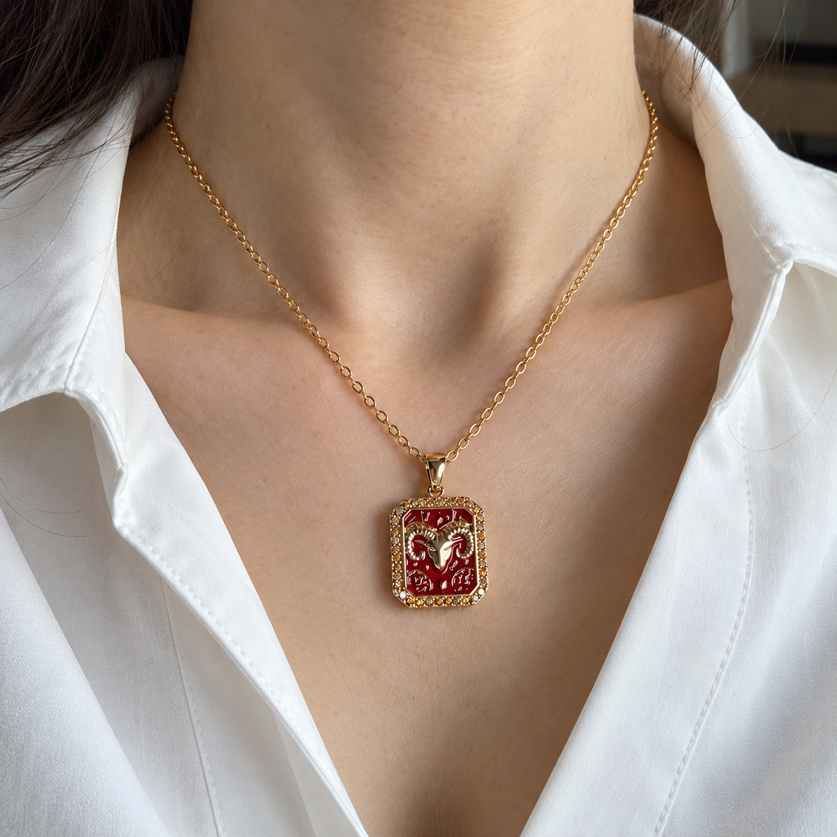 Aries zodiac necklace worn with white shirt