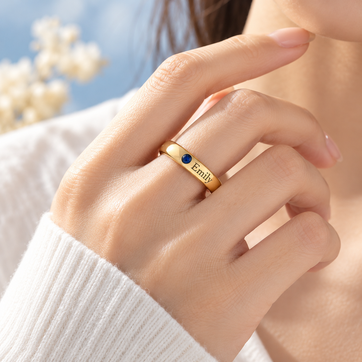 Gold personalized ring shown on hand